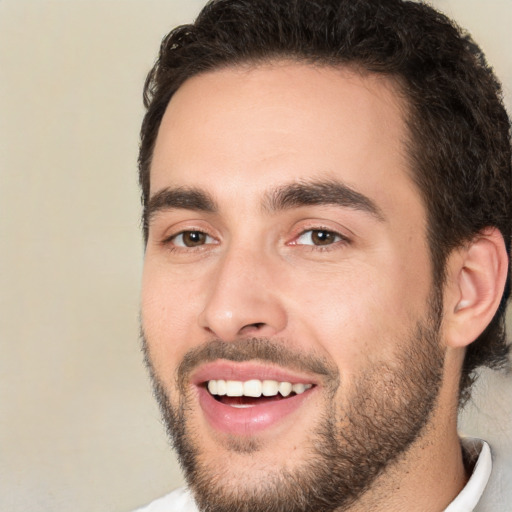 Joyful white young-adult male with short  black hair and brown eyes