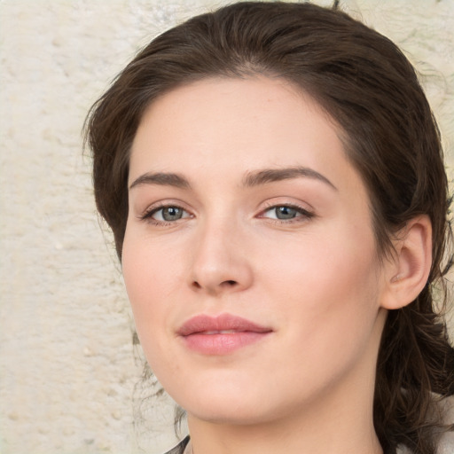 Joyful white young-adult female with medium  brown hair and green eyes