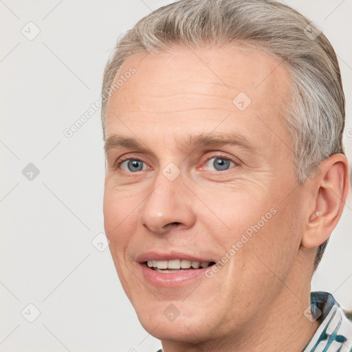 Joyful white adult male with short  brown hair and grey eyes