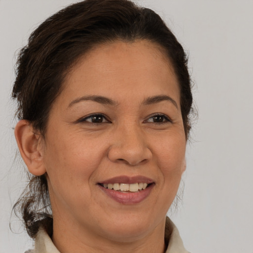 Joyful white adult female with medium  brown hair and brown eyes