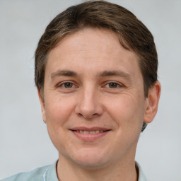 Joyful white adult male with short  brown hair and brown eyes