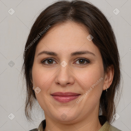 Joyful white adult female with medium  brown hair and brown eyes