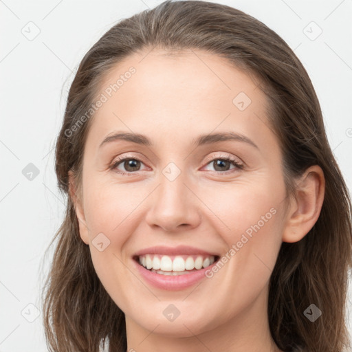 Joyful white young-adult female with long  brown hair and grey eyes