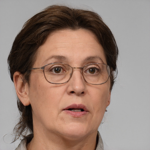 Neutral white middle-aged female with medium  brown hair and grey eyes