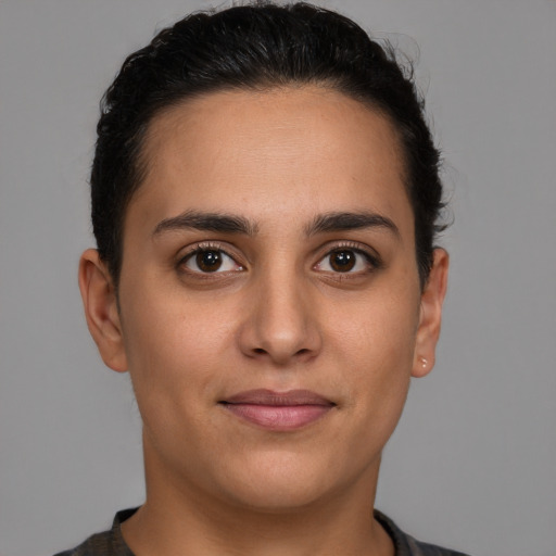 Joyful latino young-adult female with short  brown hair and brown eyes