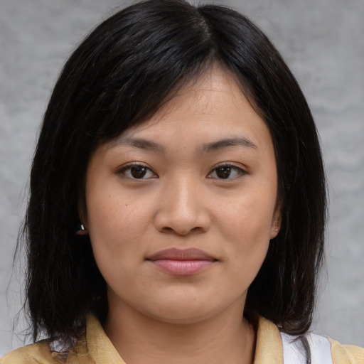 Joyful asian young-adult female with medium  brown hair and brown eyes