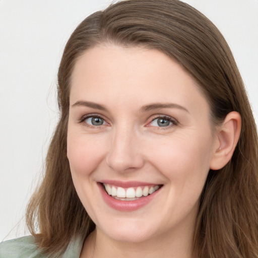 Joyful white young-adult female with long  brown hair and blue eyes