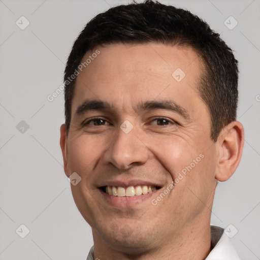 Joyful white adult male with short  brown hair and brown eyes