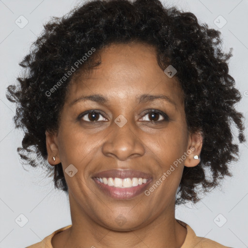 Joyful black adult female with short  brown hair and brown eyes