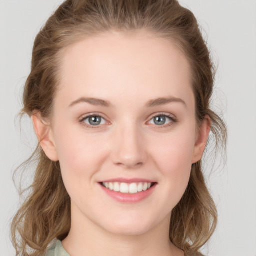 Joyful white young-adult female with medium  brown hair and blue eyes