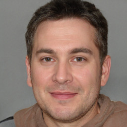 Joyful white adult male with short  brown hair and brown eyes