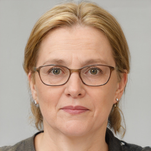 Joyful white adult female with medium  brown hair and blue eyes