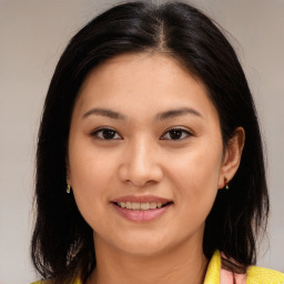 Joyful asian young-adult female with long  brown hair and brown eyes