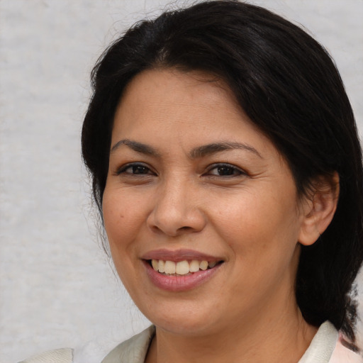 Joyful white adult female with medium  brown hair and brown eyes