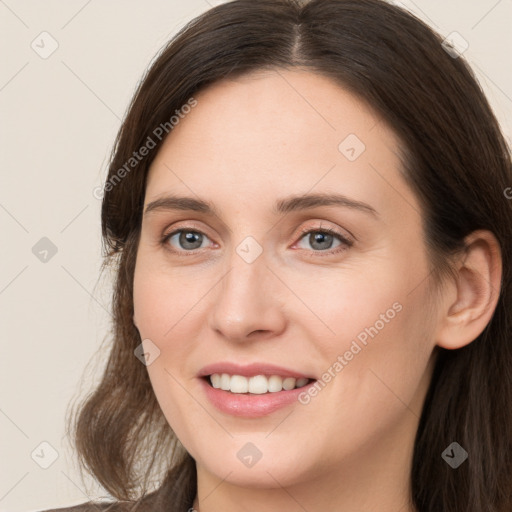 Joyful white young-adult female with long  brown hair and grey eyes