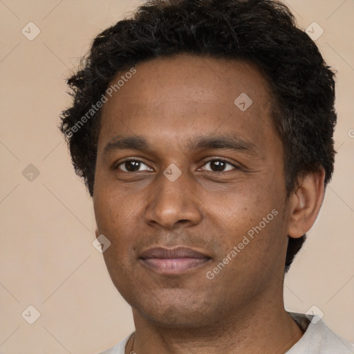 Joyful latino young-adult male with short  brown hair and brown eyes