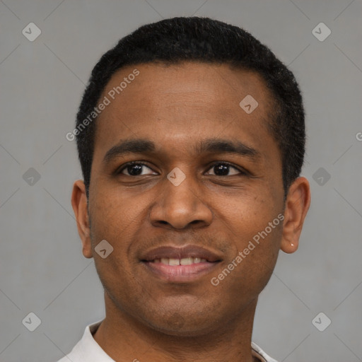 Joyful latino young-adult male with short  brown hair and brown eyes