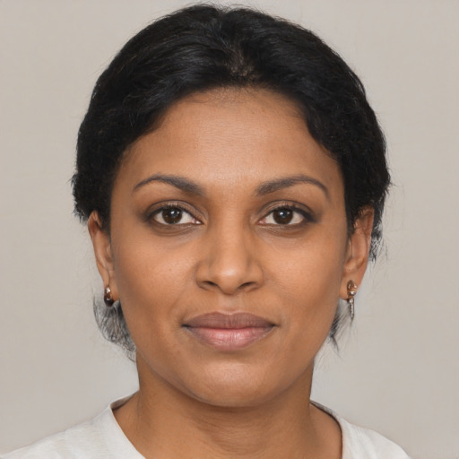 Joyful black young-adult female with short  brown hair and brown eyes