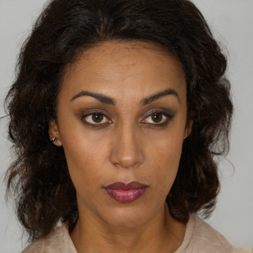 Neutral latino adult female with medium  brown hair and brown eyes