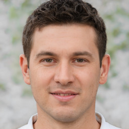 Joyful white young-adult male with short  brown hair and brown eyes