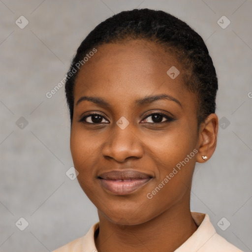 Joyful black young-adult female with short  black hair and brown eyes