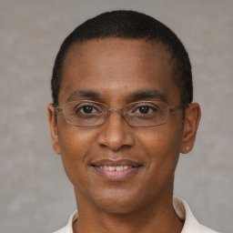 Joyful black adult male with short  brown hair and brown eyes