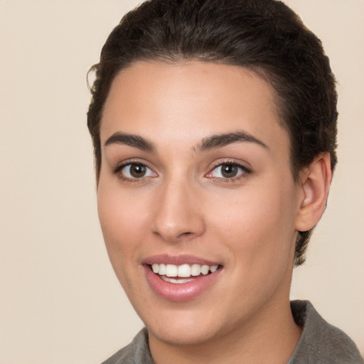 Joyful white young-adult female with short  brown hair and brown eyes