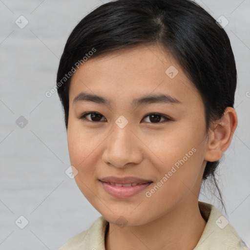 Joyful asian young-adult female with medium  brown hair and brown eyes