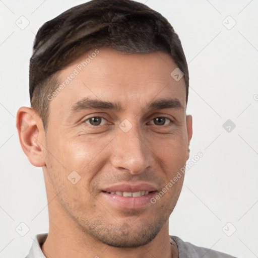 Joyful white young-adult male with short  brown hair and brown eyes