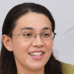 Joyful white adult female with long  brown hair and brown eyes