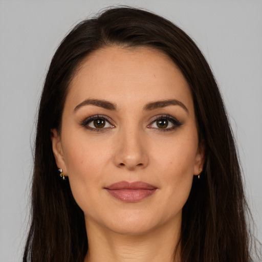 Joyful white young-adult female with long  brown hair and brown eyes