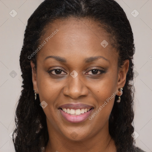 Joyful black adult female with long  brown hair and brown eyes