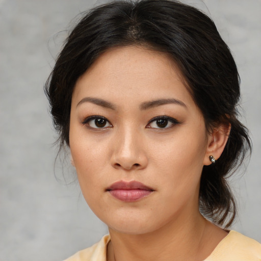 Joyful asian young-adult female with medium  brown hair and brown eyes