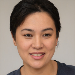 Joyful asian young-adult female with short  brown hair and brown eyes