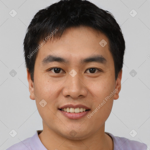 Joyful asian young-adult male with short  black hair and brown eyes