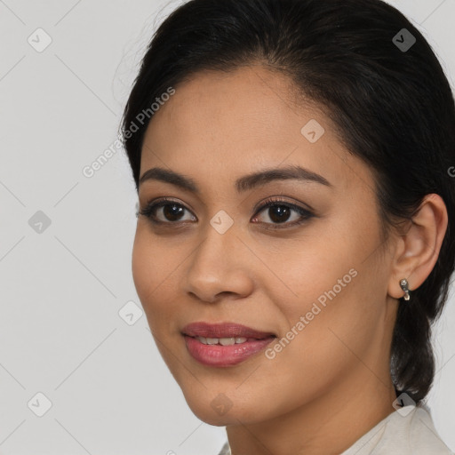 Joyful latino young-adult female with medium  brown hair and brown eyes