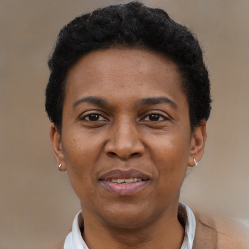 Joyful black adult female with short  black hair and brown eyes