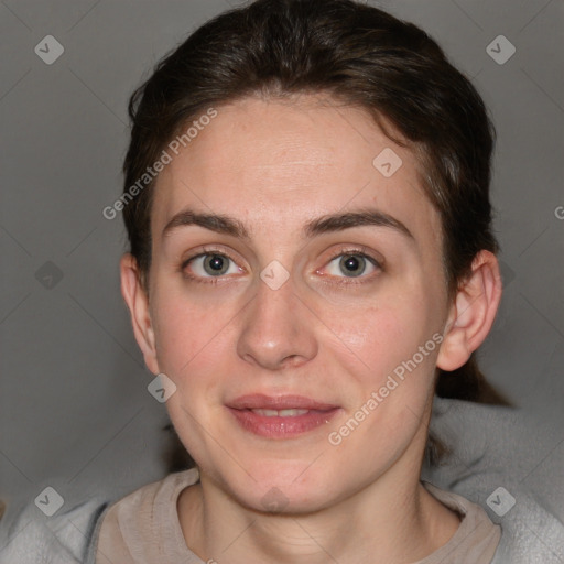 Joyful white adult female with short  brown hair and grey eyes