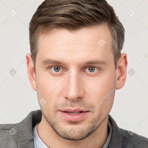 Joyful white young-adult male with short  brown hair and grey eyes