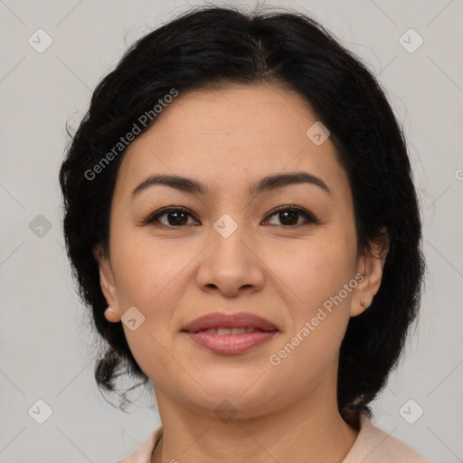 Joyful latino adult female with medium  brown hair and brown eyes