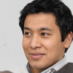 Joyful latino adult male with short  black hair and brown eyes