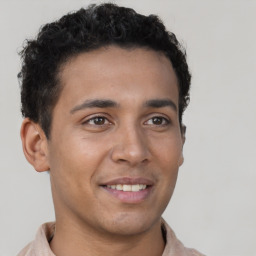 Joyful latino young-adult male with short  brown hair and brown eyes