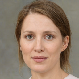 Joyful white adult female with medium  brown hair and green eyes