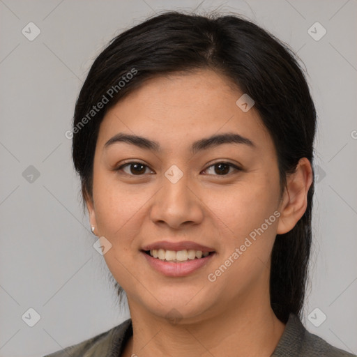 Joyful latino young-adult female with medium  brown hair and brown eyes