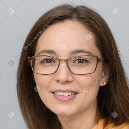 Joyful white adult female with long  brown hair and grey eyes