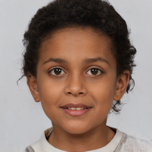 Joyful black child female with short  brown hair and brown eyes