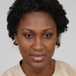 Joyful black adult female with short  brown hair and brown eyes