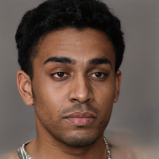 Neutral black young-adult male with short  black hair and brown eyes