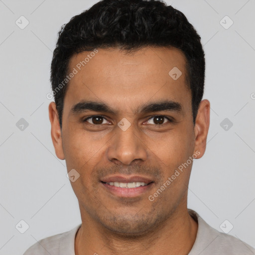 Joyful latino young-adult male with short  black hair and brown eyes