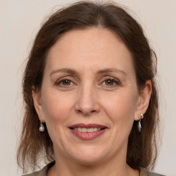 Joyful white adult female with medium  brown hair and grey eyes